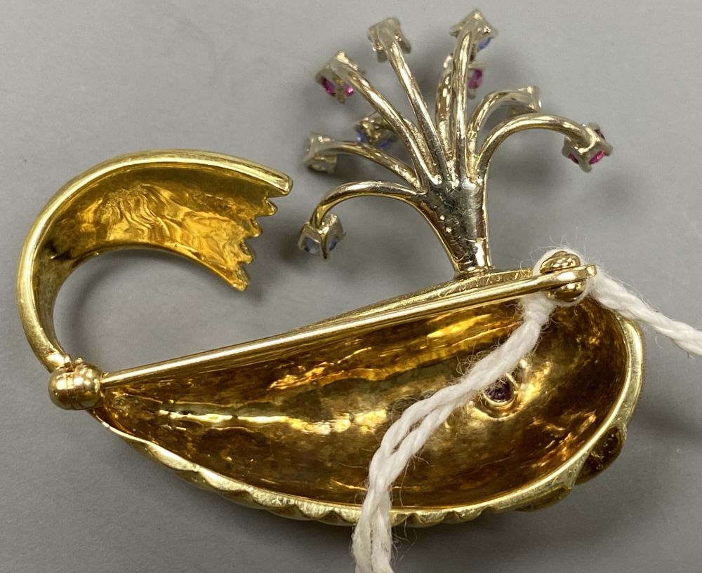 A novelty continental yellow metal (engraved 14k), ruby diamond and sapphire set happy whale brooch,